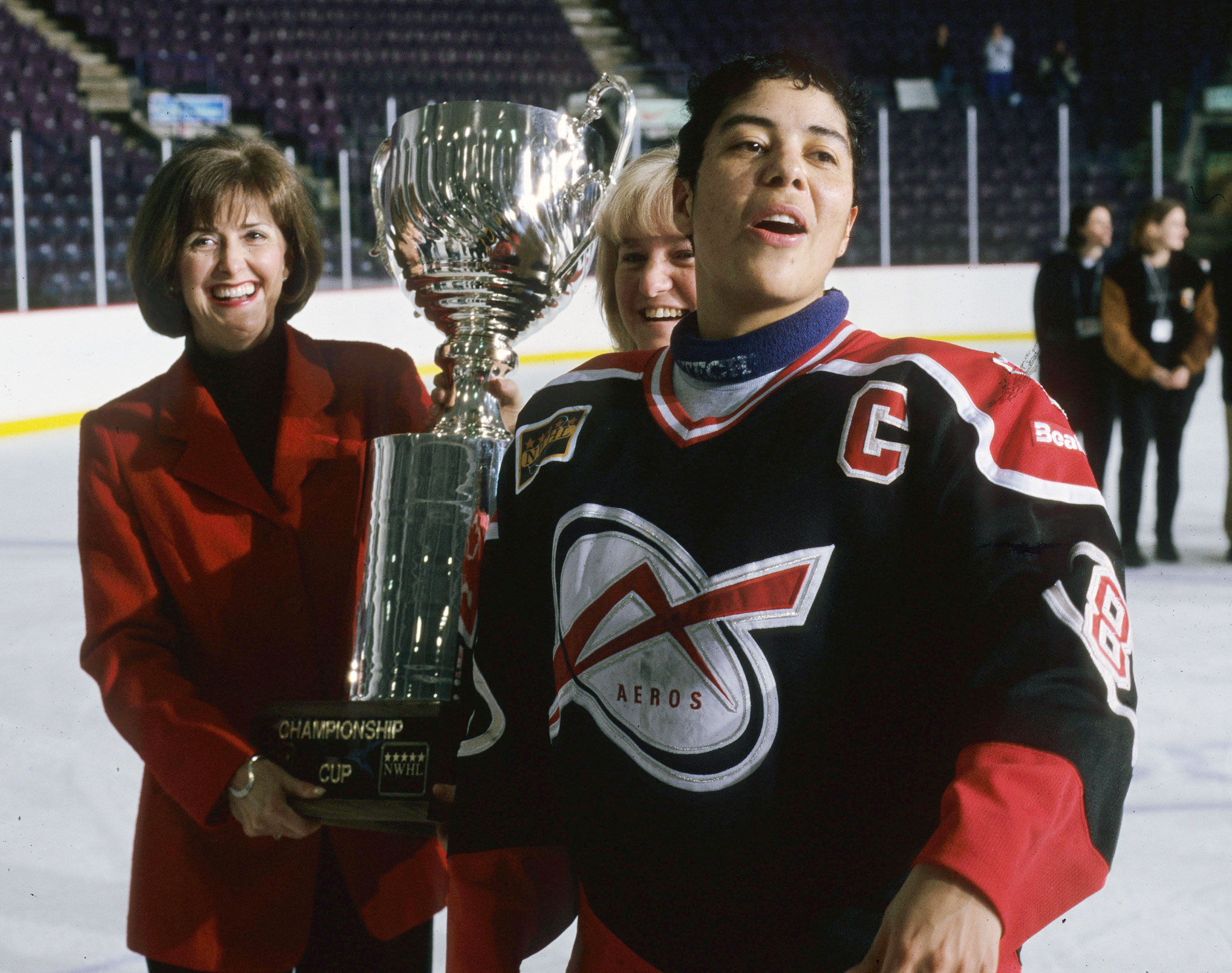 Angela James accepts the NWHL Championship trophy as captain of the Beatrice Aeros. 